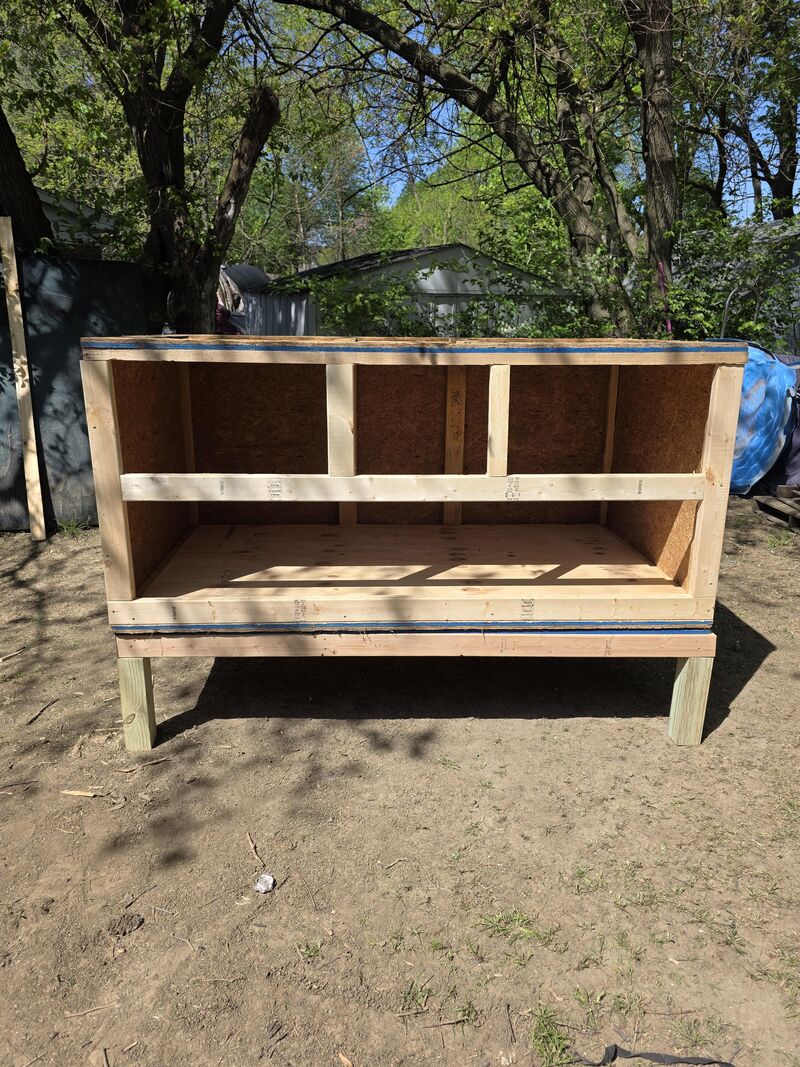 My coop, that's a work in progress but nowhere near done. How do you guys think I should do my nesting boxes? I was considering building out for the boxes, but was thinking of taking an easy route and do milk crates with doors on the side. Its 48 inches wide, so it has plenty of room inside.